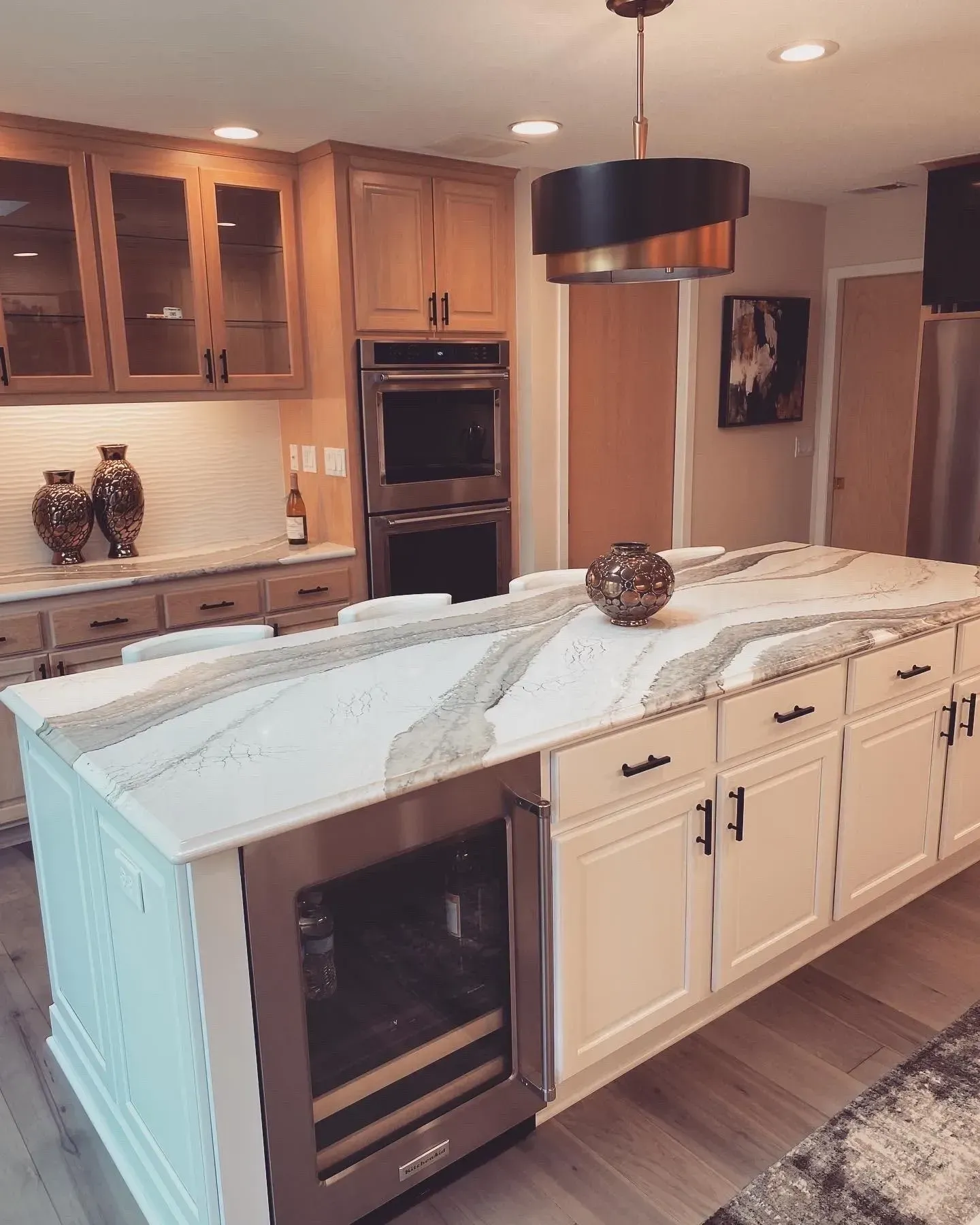 A kitchen with a large island and stainless steel appliances