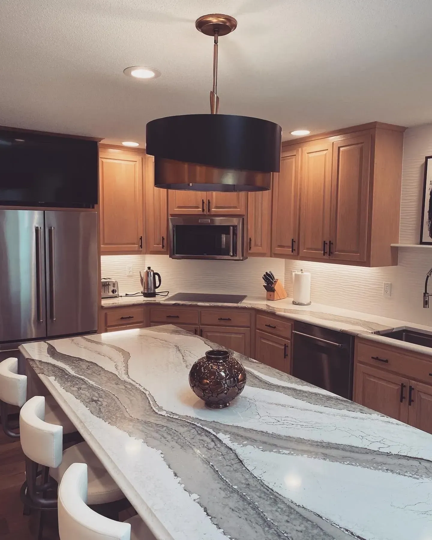 A kitchen with wooden cabinets and stainless steel appliances