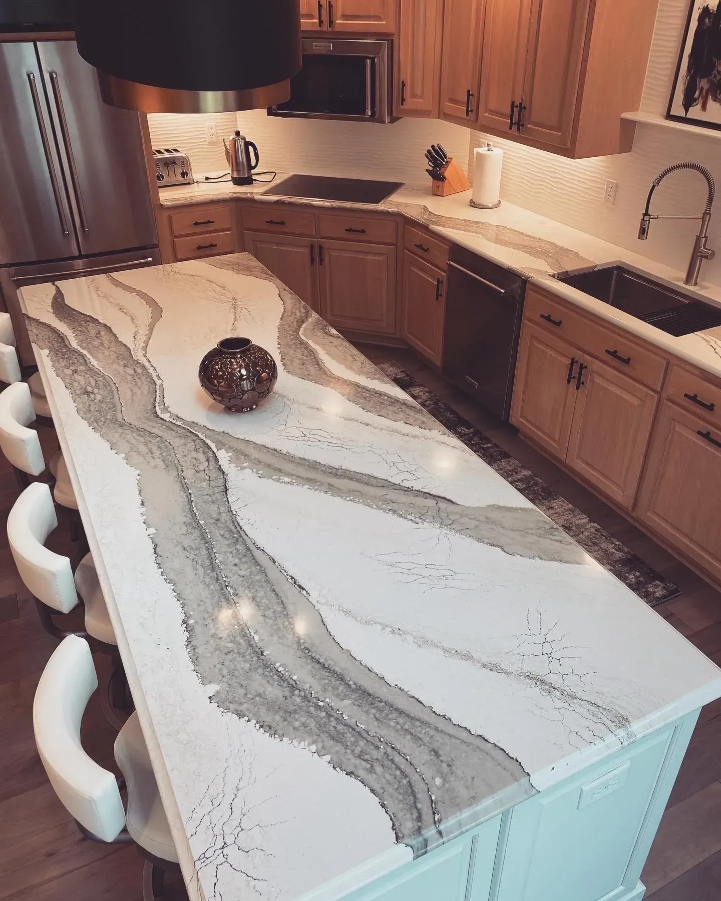 A kitchen with a large island and a sink