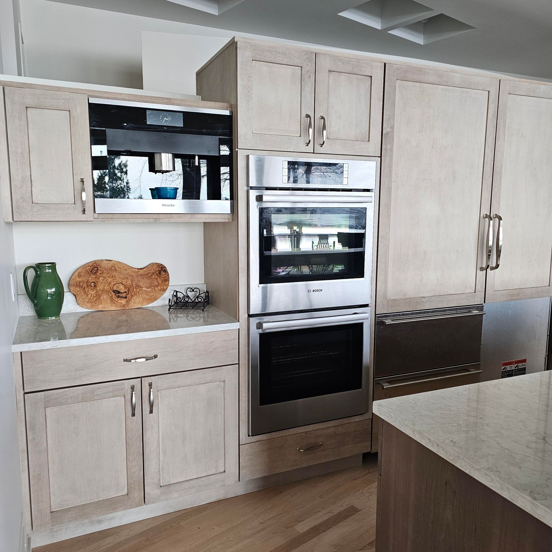 A kitchen with stainless steel appliances and wooden cabinets