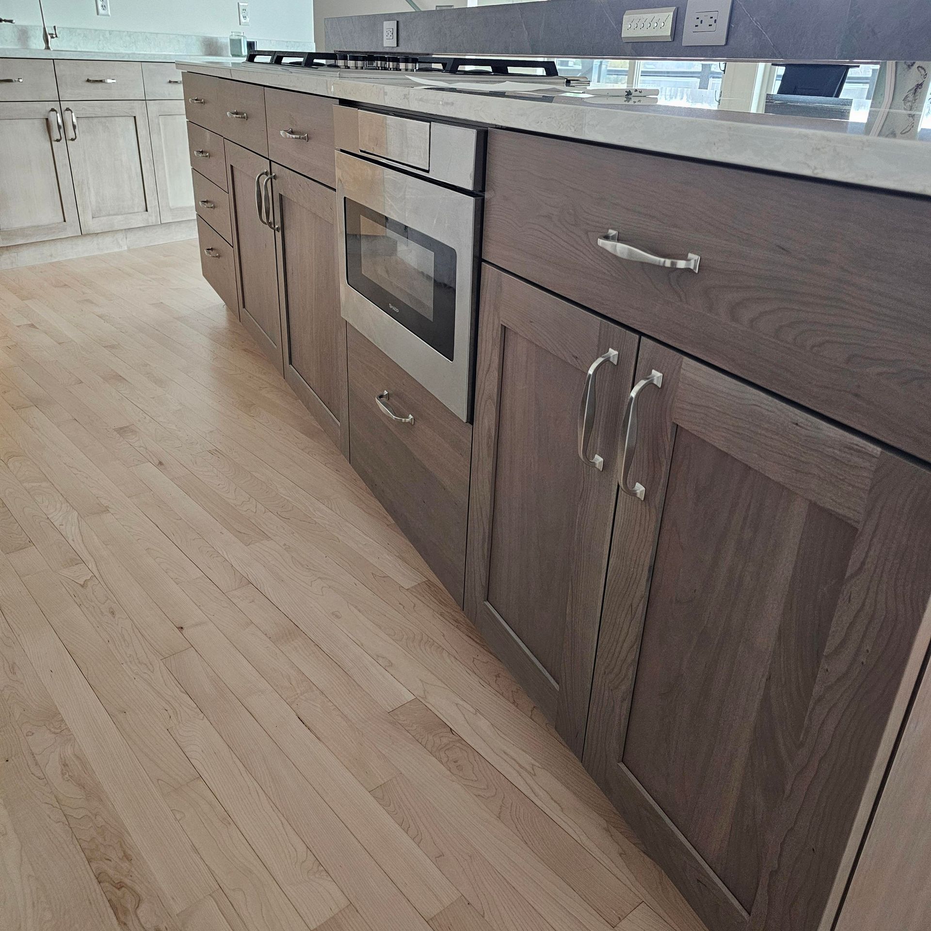 A kitchen with wooden cabinets and stainless steel appliances