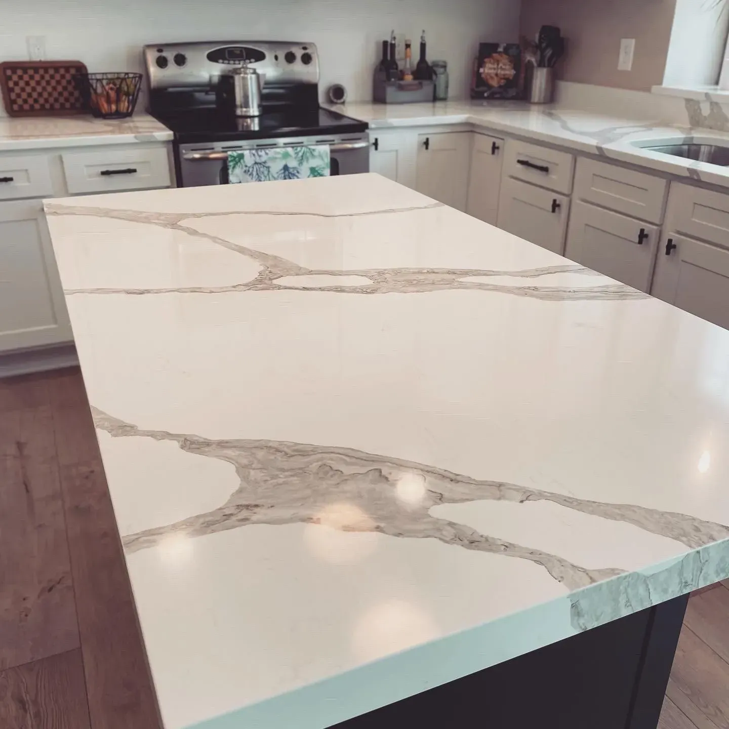 A kitchen with a large white counter top and a stove