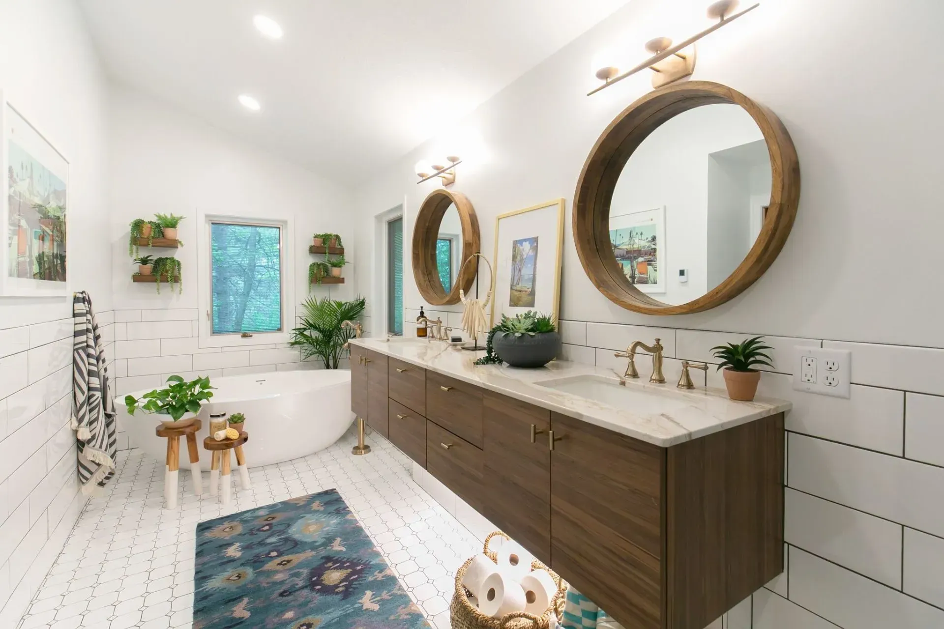 A bathroom with two sinks , two mirrors and a bathtub.