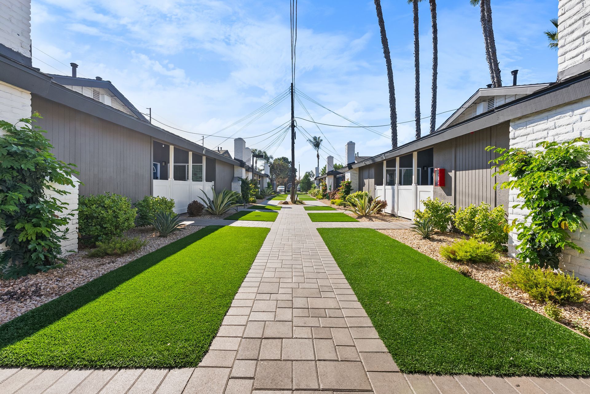Exterior Photo of Property - turf and single story apartments