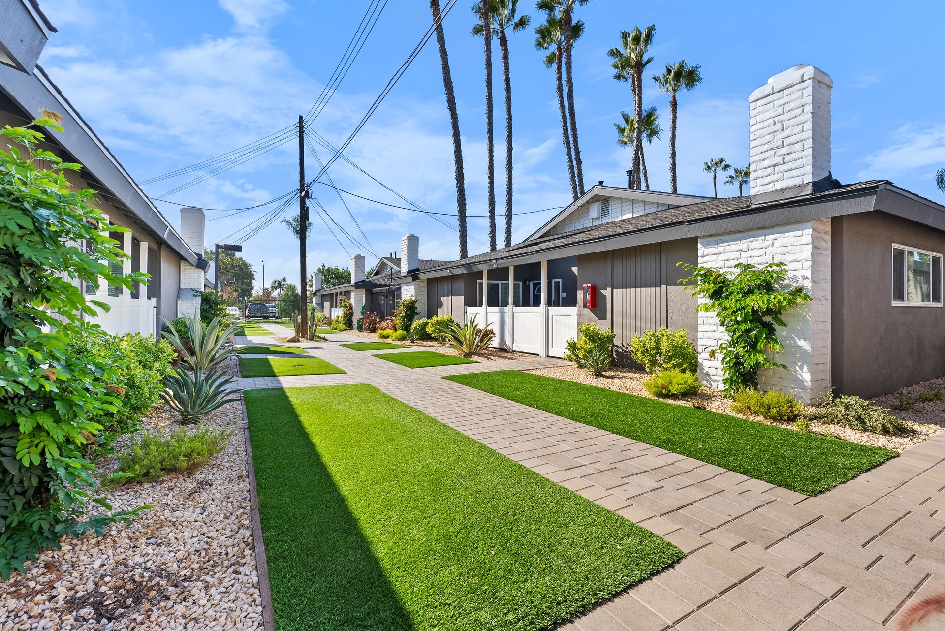 Exterior Photo of Property - turf and single story apartments