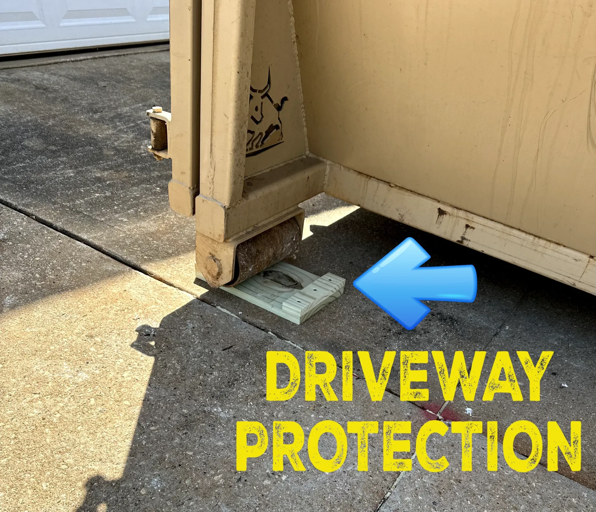 A dumpster is sitting on the sidewalk with a blue arrow pointing to it.