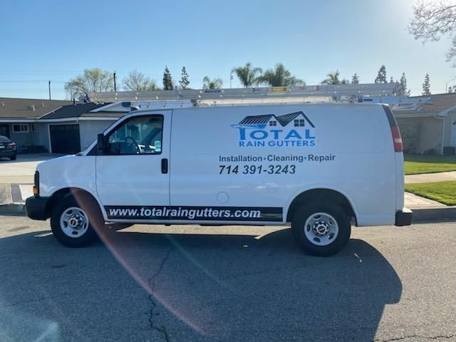 a white van for total rain gutters is parked on the side of the road