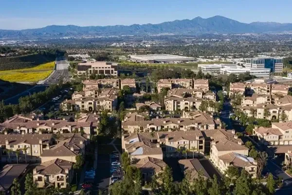 an aerial view of a residential area with mountains in the background .