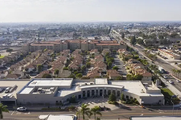 an aerial view of a city with a large building in the middle of it .