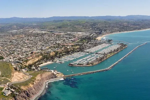 an aerial view of a city next to a body of water .