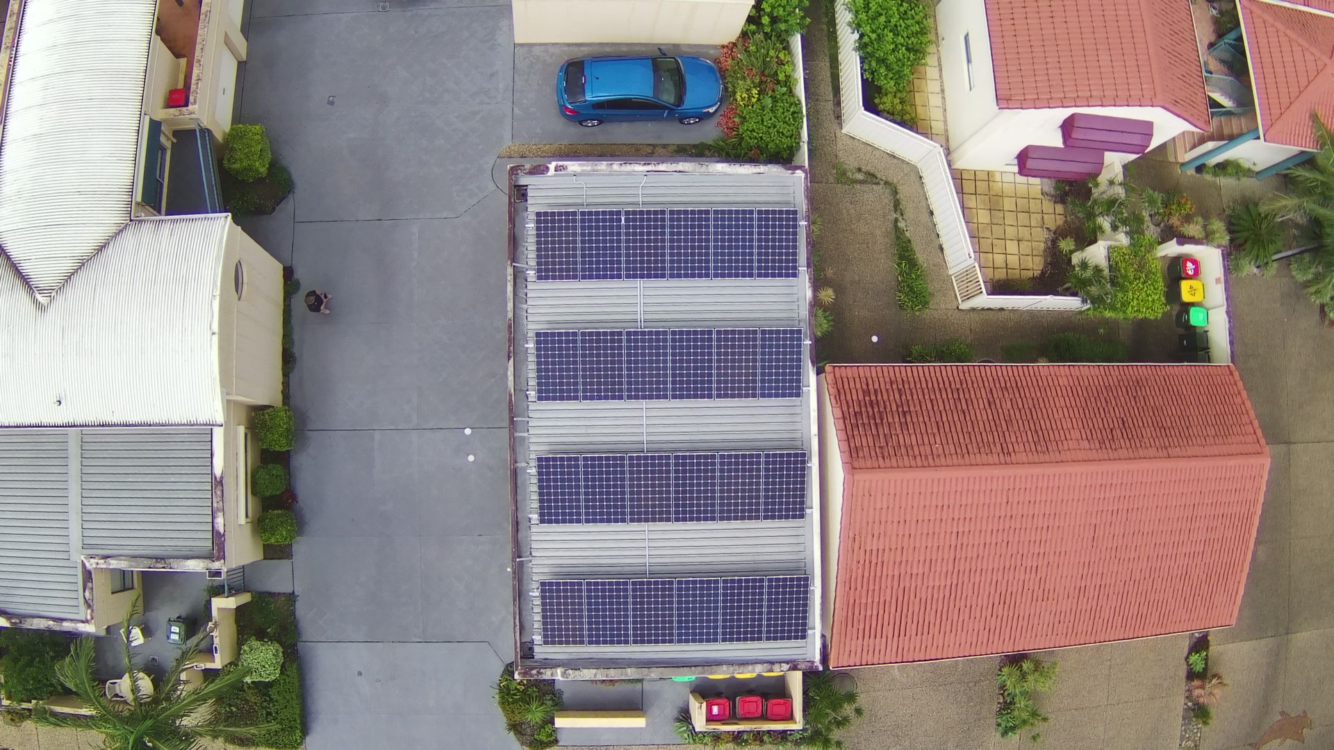 Aerial View Of A Building Rooftop Covered With Solar Panels — Mackies in Taree, NSW