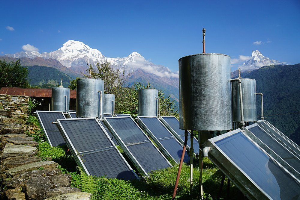 Solar Panels With Water Tanks In A Mountainous Setting — Mackies In Forster, NSW