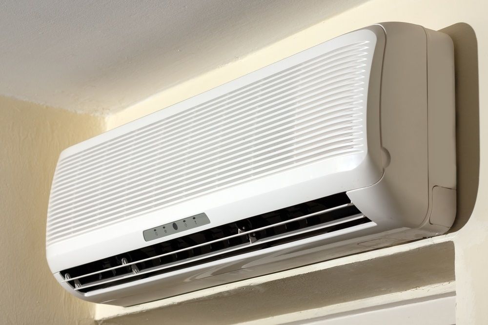 White Wall-mounted Air Conditioning Unit On A Beige Wall — Mackies In Coffs Harbour, NSW