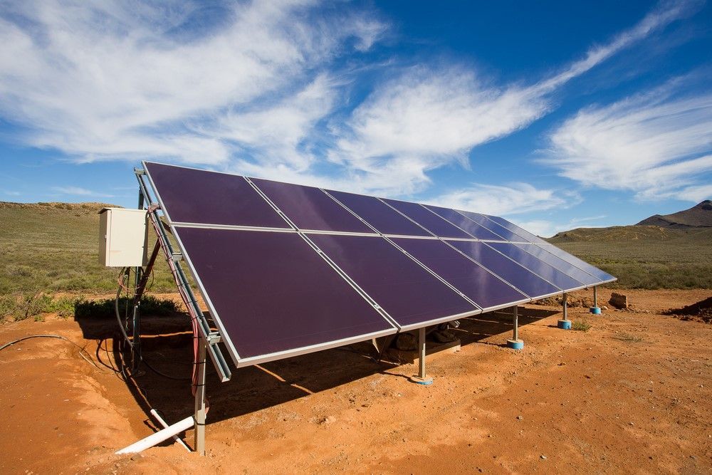 Solar Panels Installed On A Dirt Lot With A Blue Sky — Mackies In Coffs Harbour, NSW