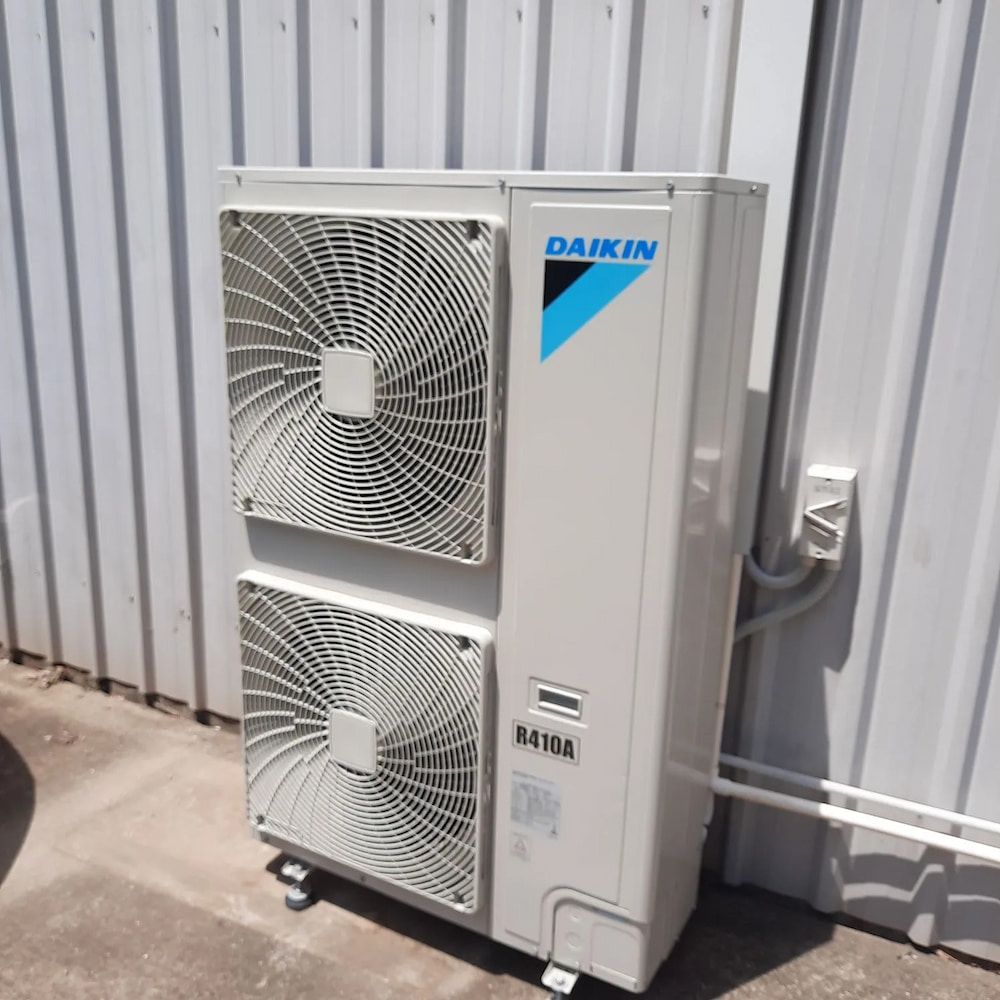 A Daikin Air Conditioner Is Sitting Outside Of A Building — Mackies In Taree, NSW