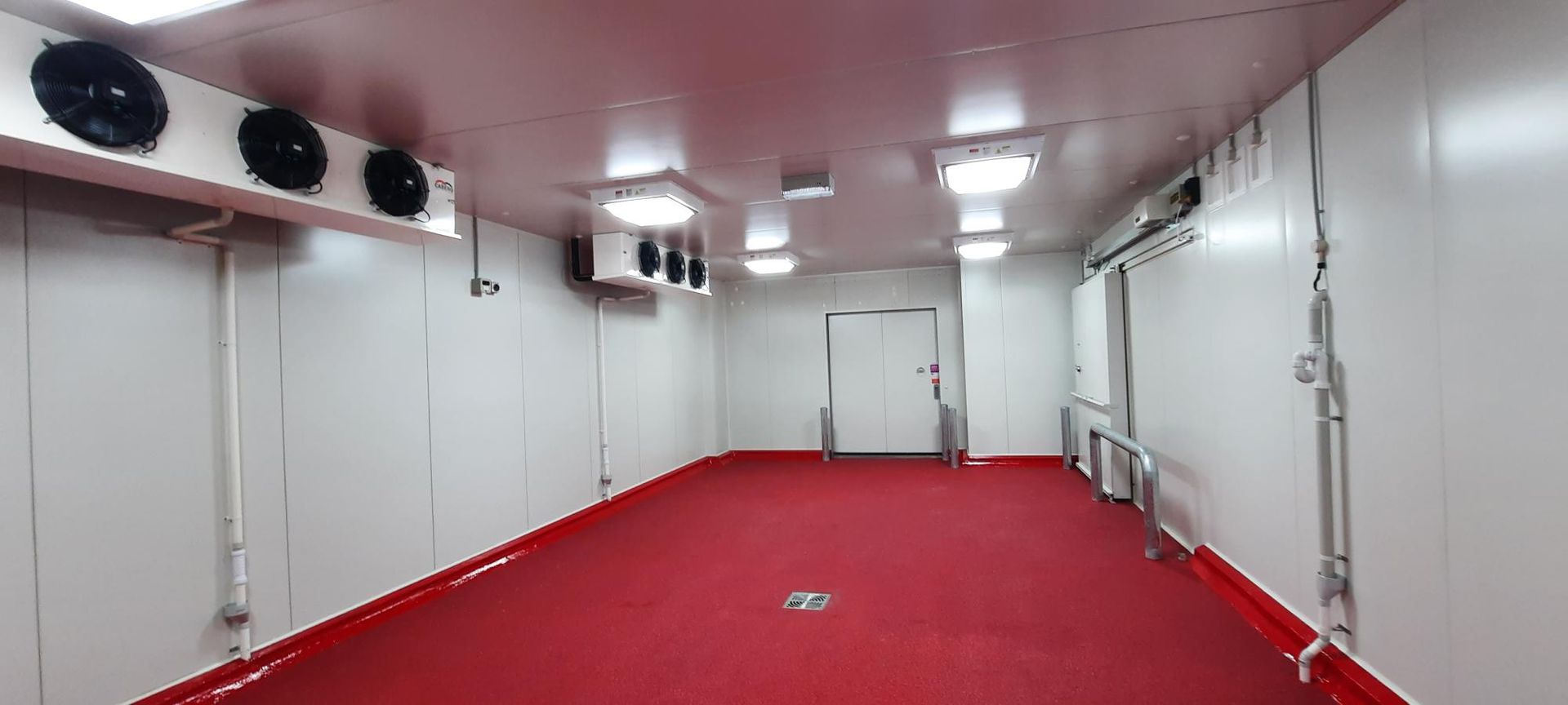 Interior Of A Large Cold Storage Room With White Walls — Mackies in Taree, NSW