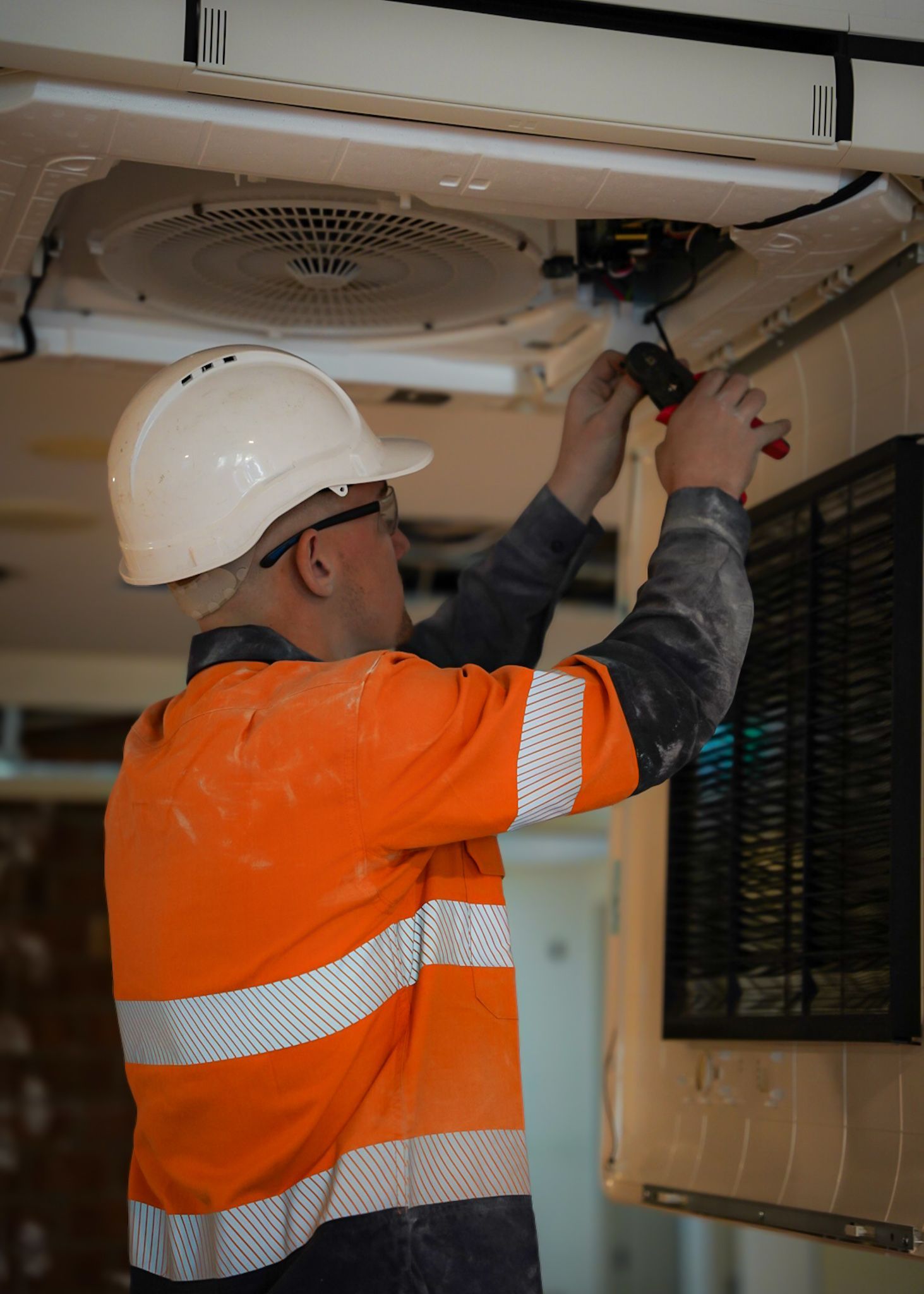 Construction Worker In Orange Safety Vest And White Hard Hat  — Mackies in Taree, NSW