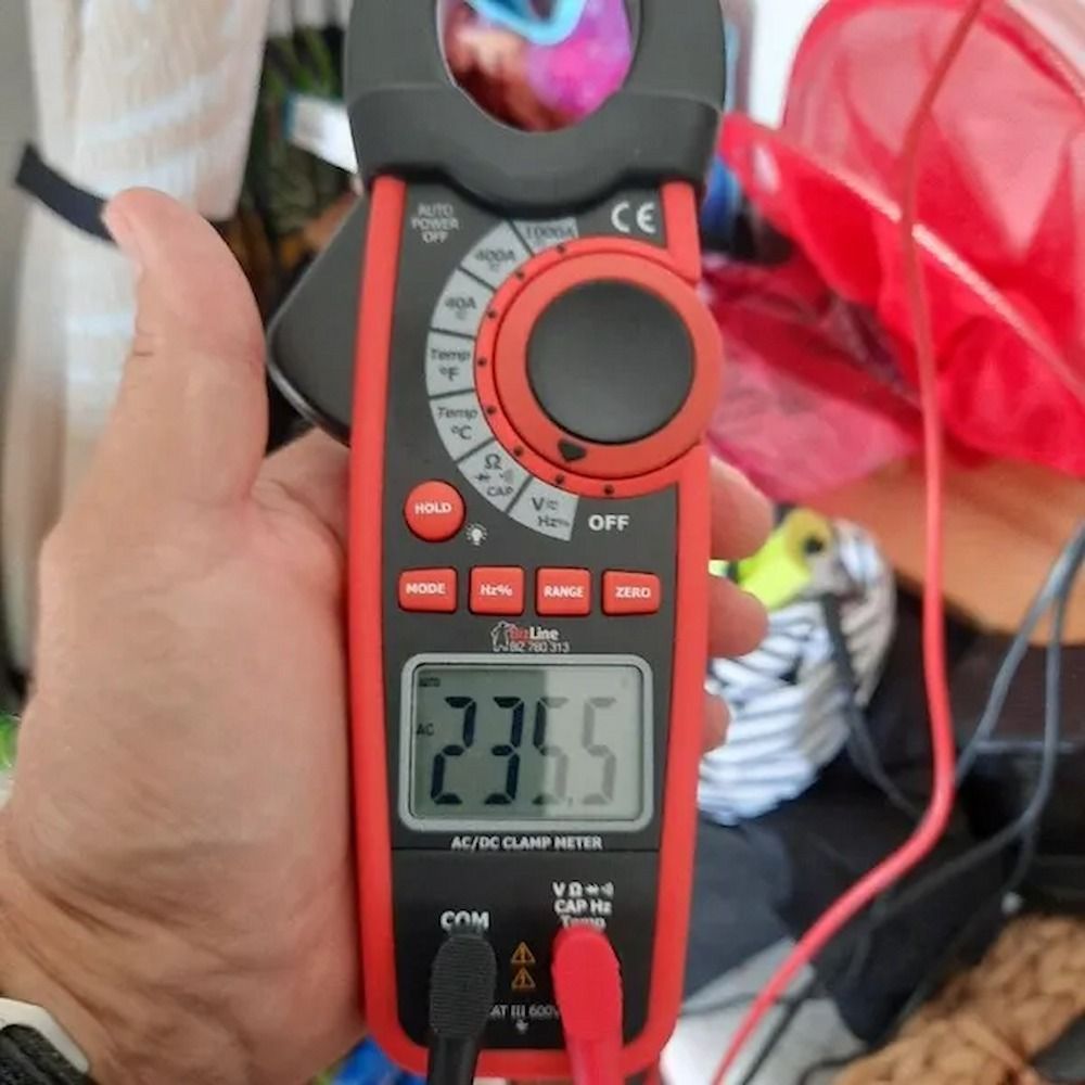A Close Up Of A Hand Holding A Clamp Meter — Mackies In Taree, NSW