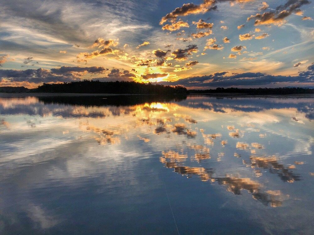 A Sunset Over A Lake With Clouds Reflected In The Water — Mackies In Old Bar, NSW
