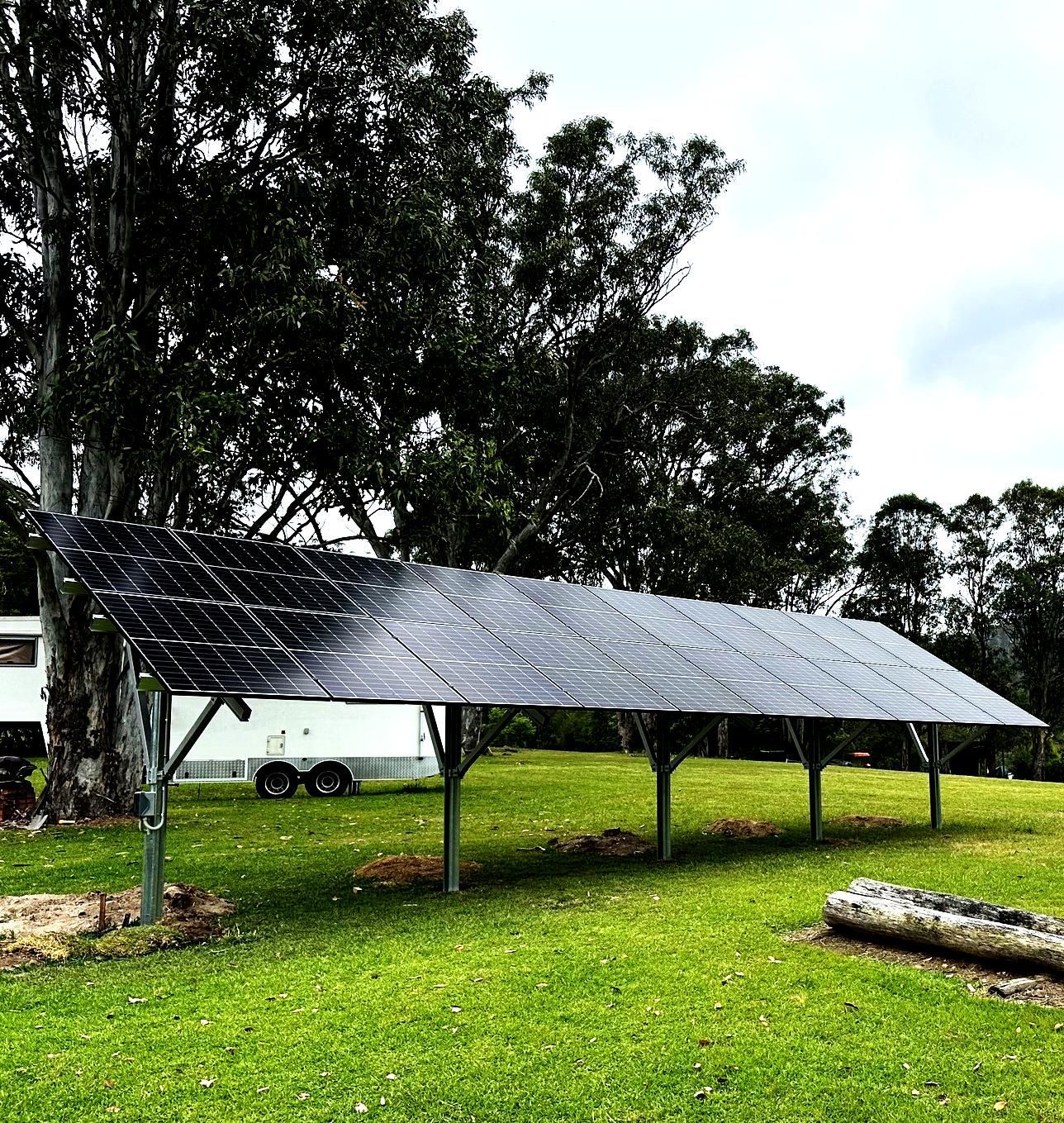 Ground-mounted Solar Panels On A Grassy Lawn — Mackies in Taree, NSW