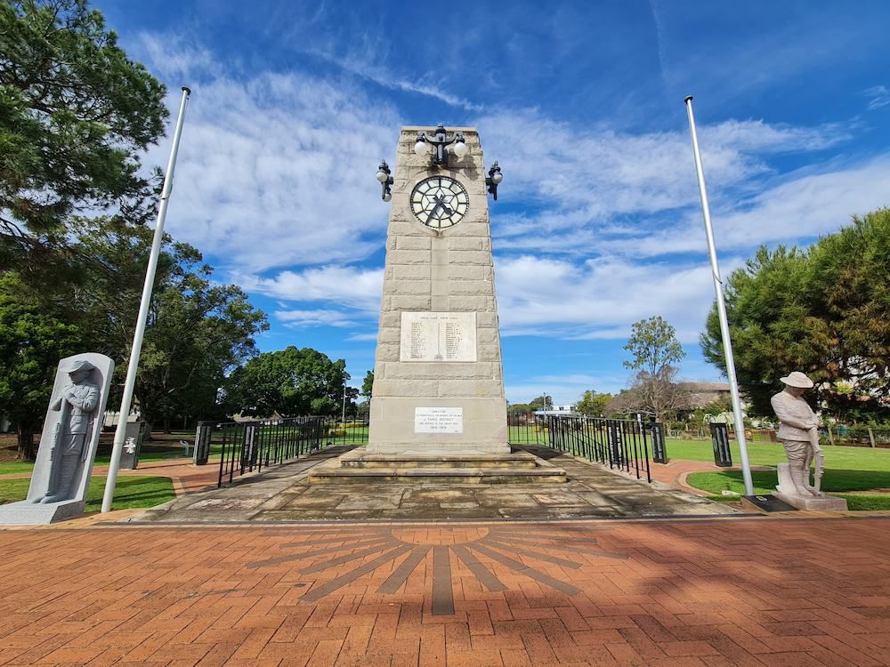 A Clock Tower With A Clock On Top Of It In A Park — Mackies In Taree, NSW