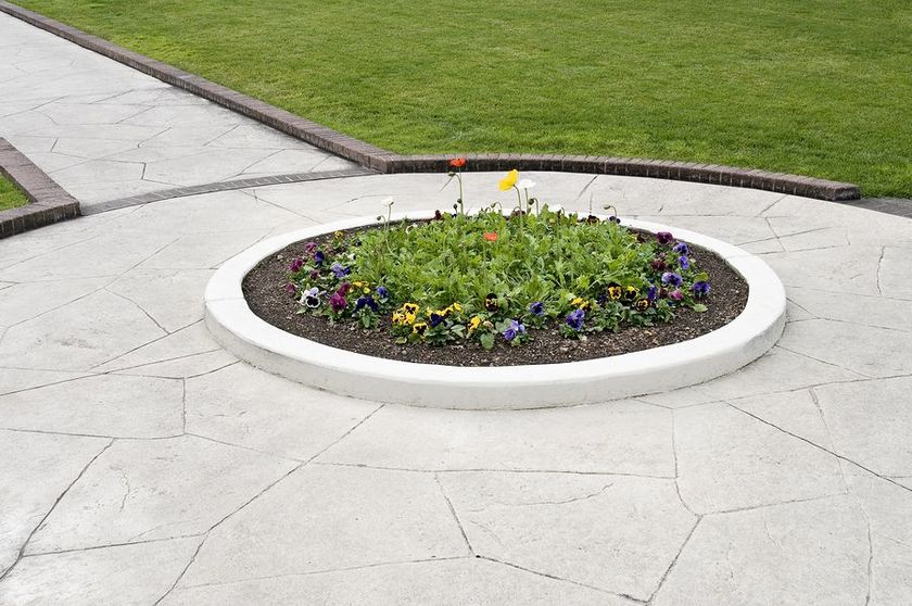 a flower bed in the middle of a walkway