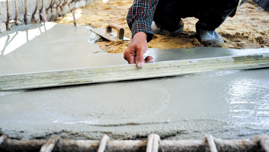 a man working on a slab of concret