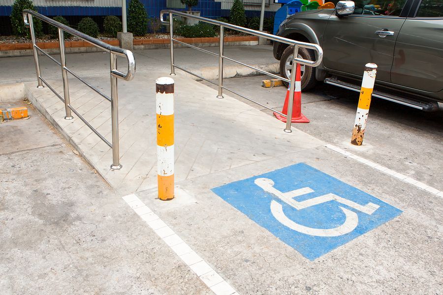 a handicapped parking lot with a handicap sign on the ground