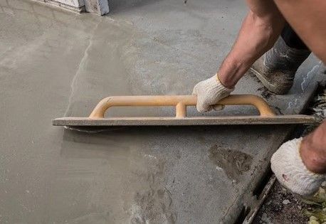 manually smoothing fresh concrete