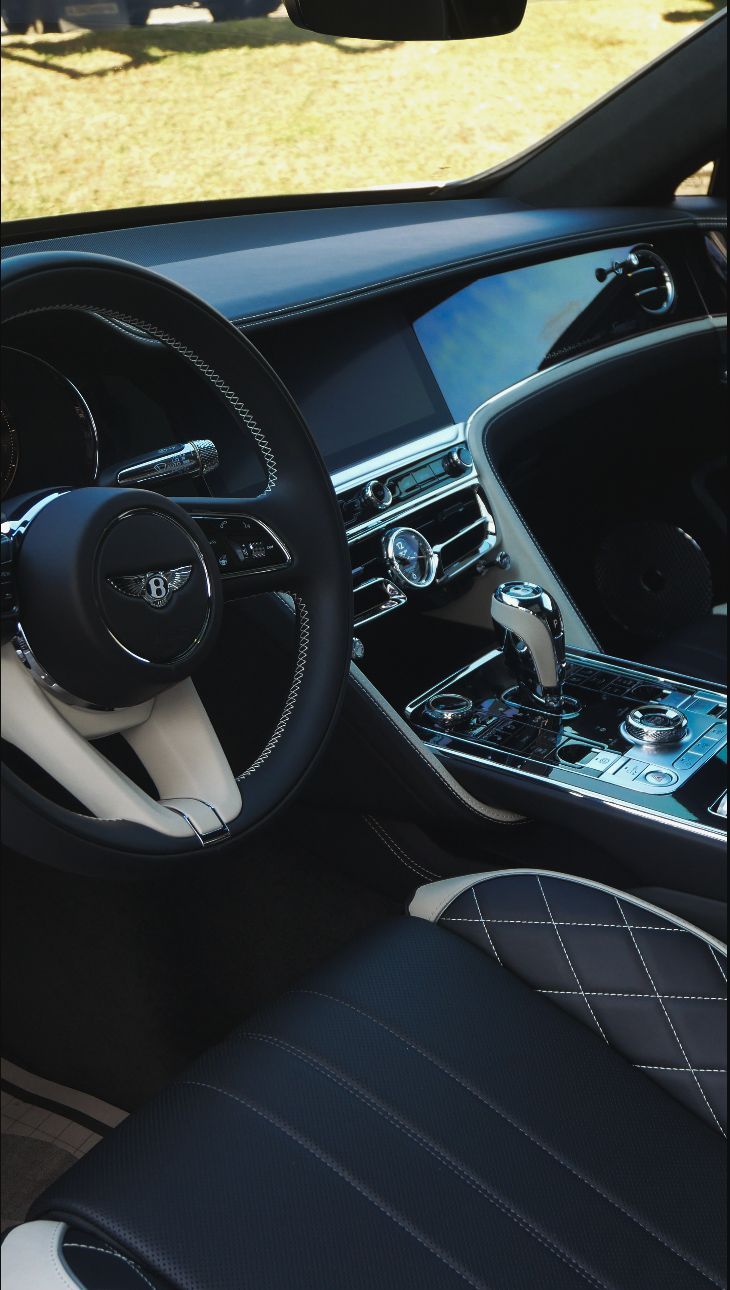 A person wearing black gloves is touching a tire