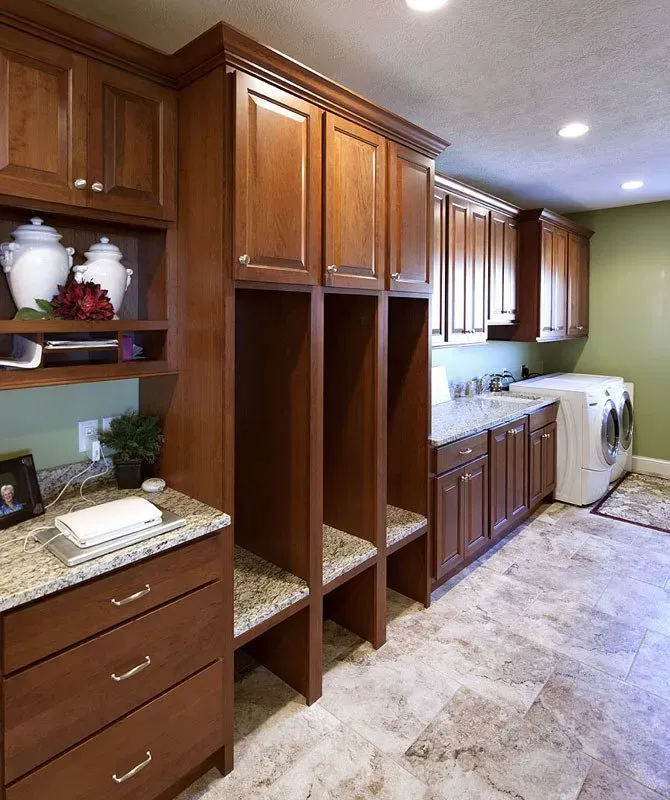Spacious laundry area with brown cabinet | St. Louis, MO | Perspective Cabinetry & Design
