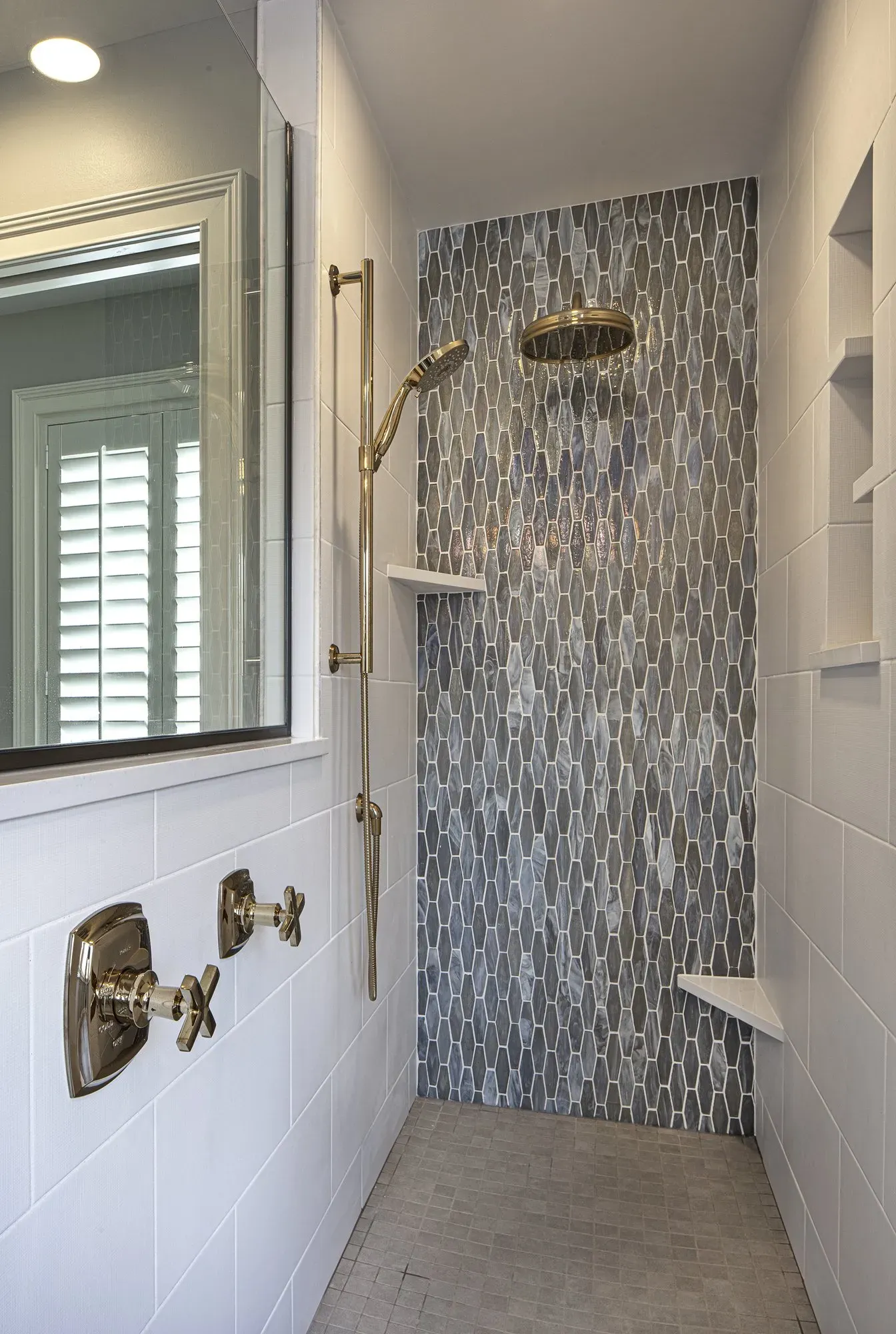 Gold shower head and white wall | St. Louis, MO | Perspective Cabinetry & Design