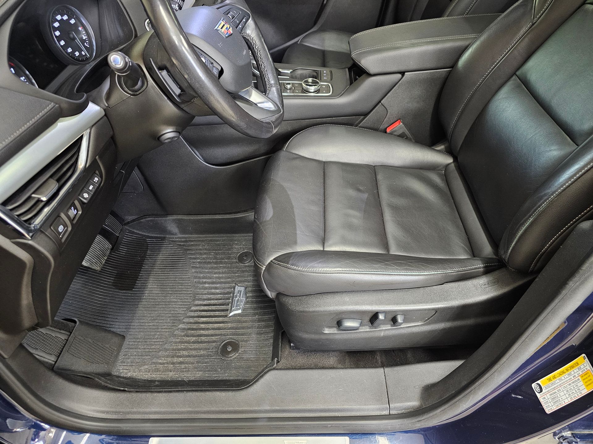 The inside of a car with the door open and the seats up.