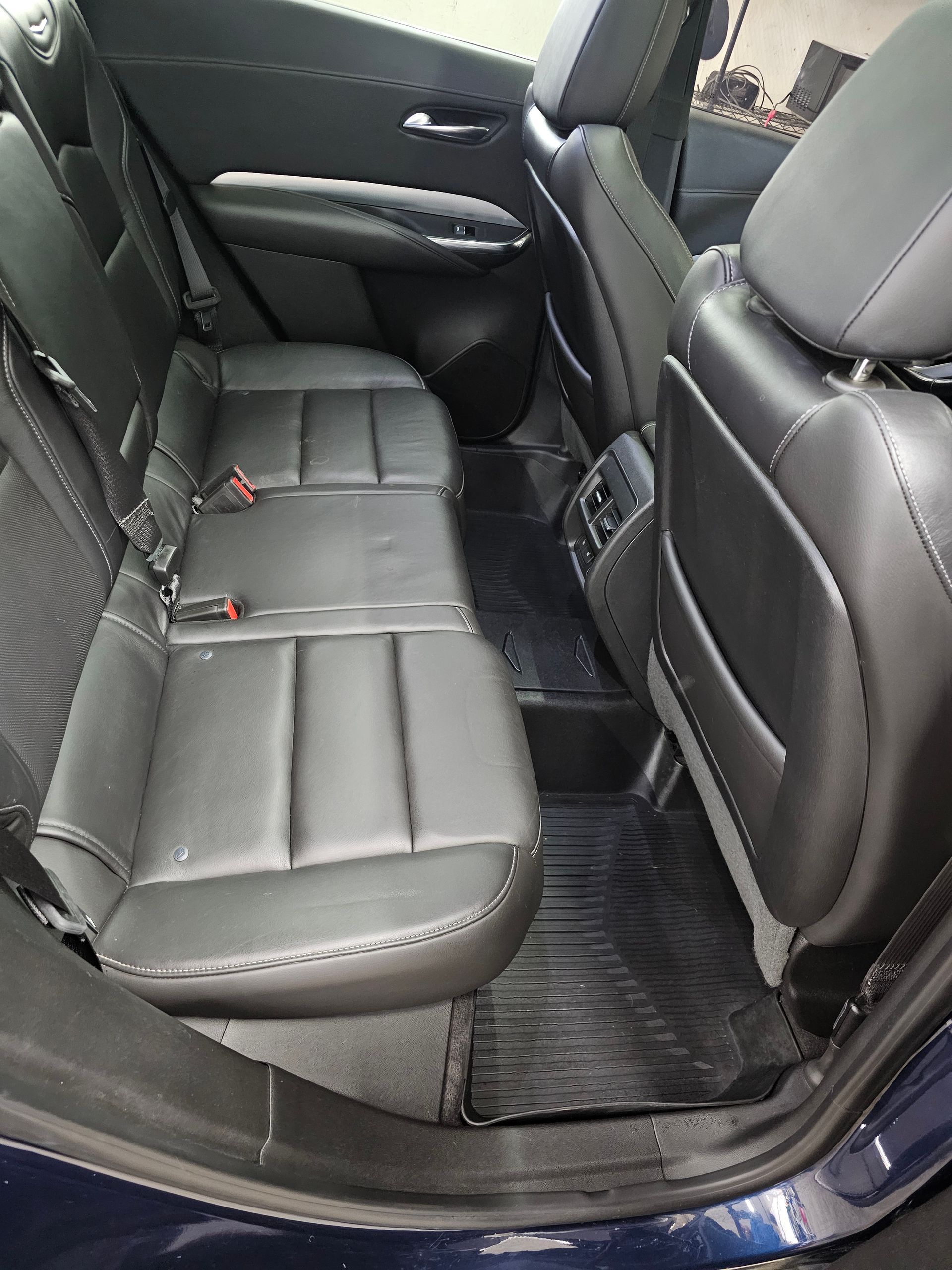 The interior of a car with a steering wheel and a radio.