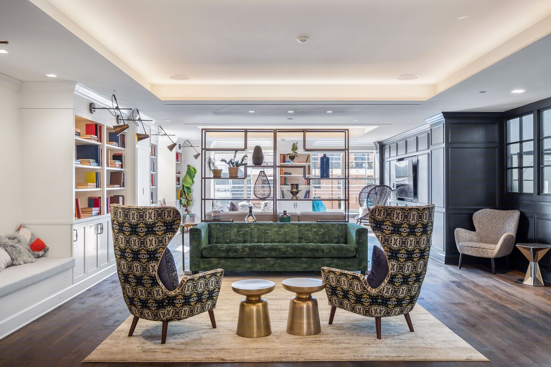 A living room with a couch , chairs and tables.