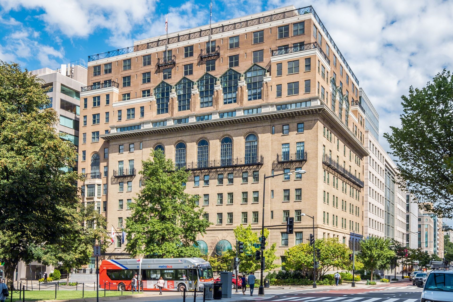 A large building with a bus parked in front of it.