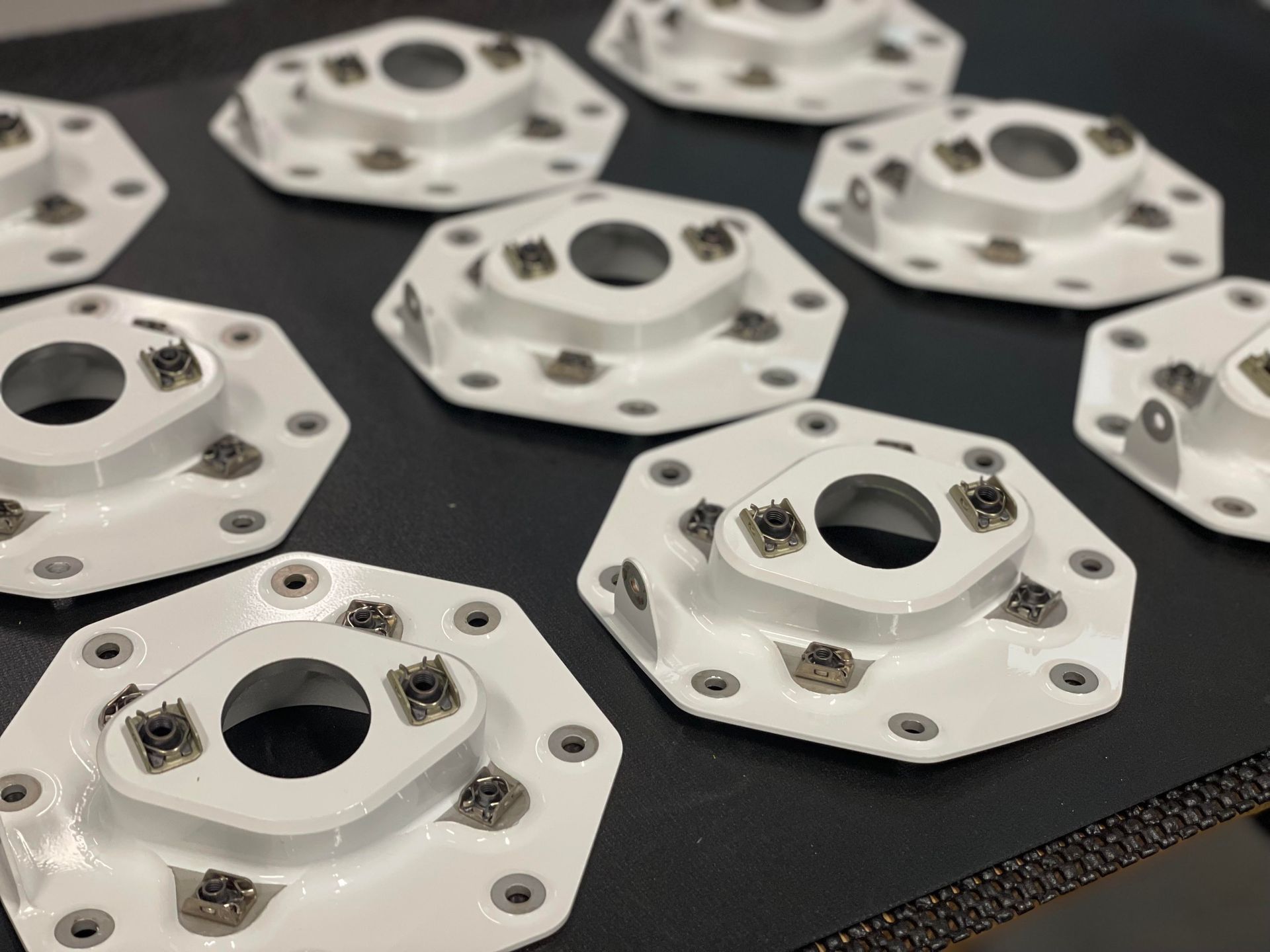 A bunch of white plates with holes in them on a table