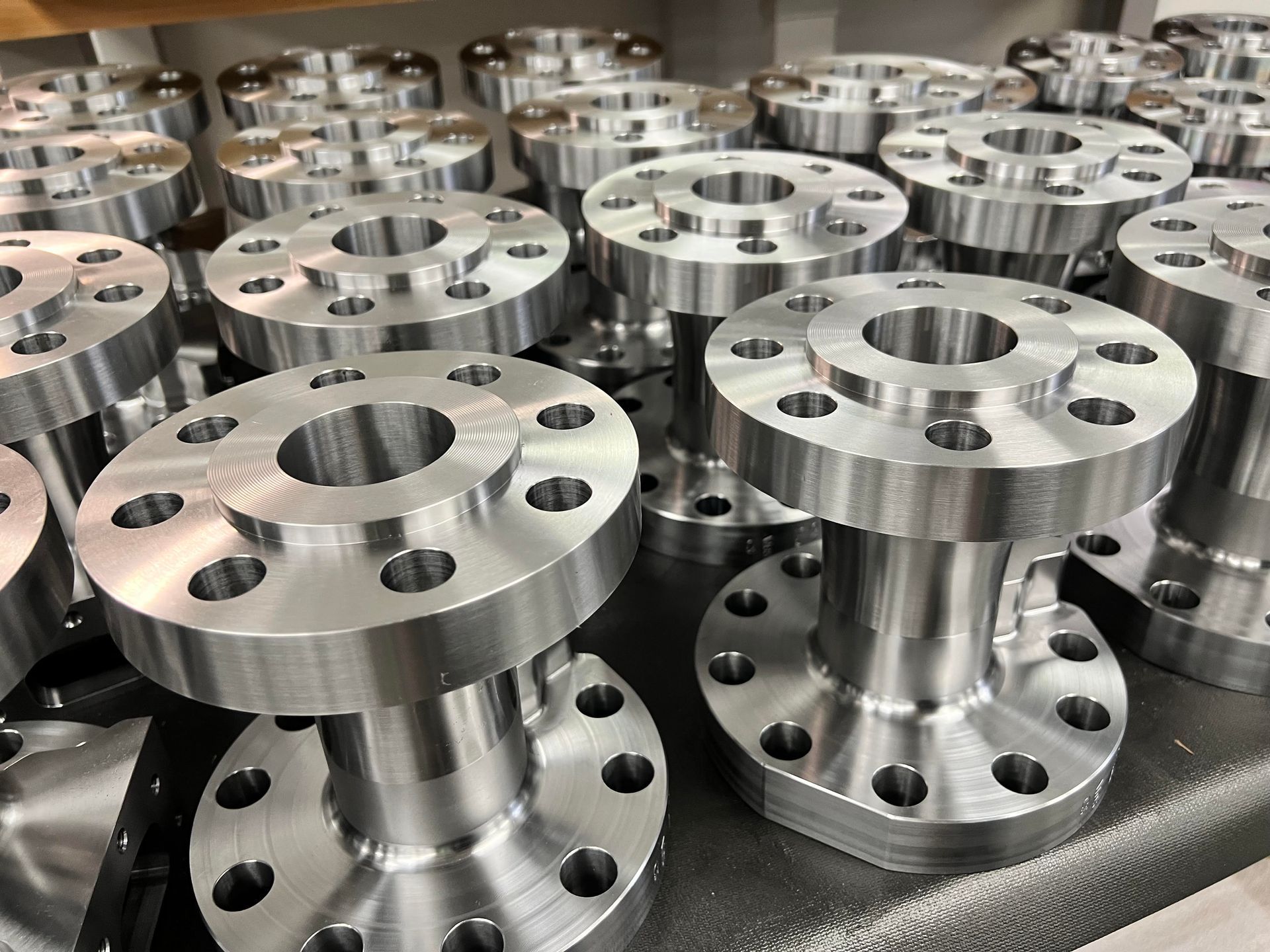 A bunch of metal pieces are sitting on top of each other on a table.