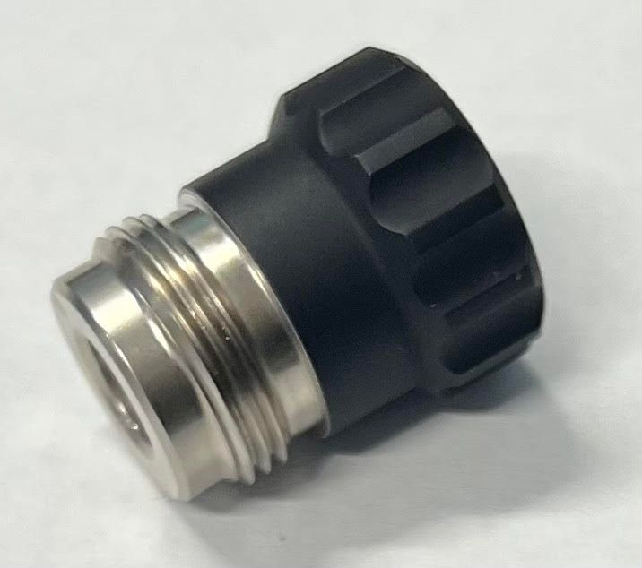 A close up of a metal object on a white surface