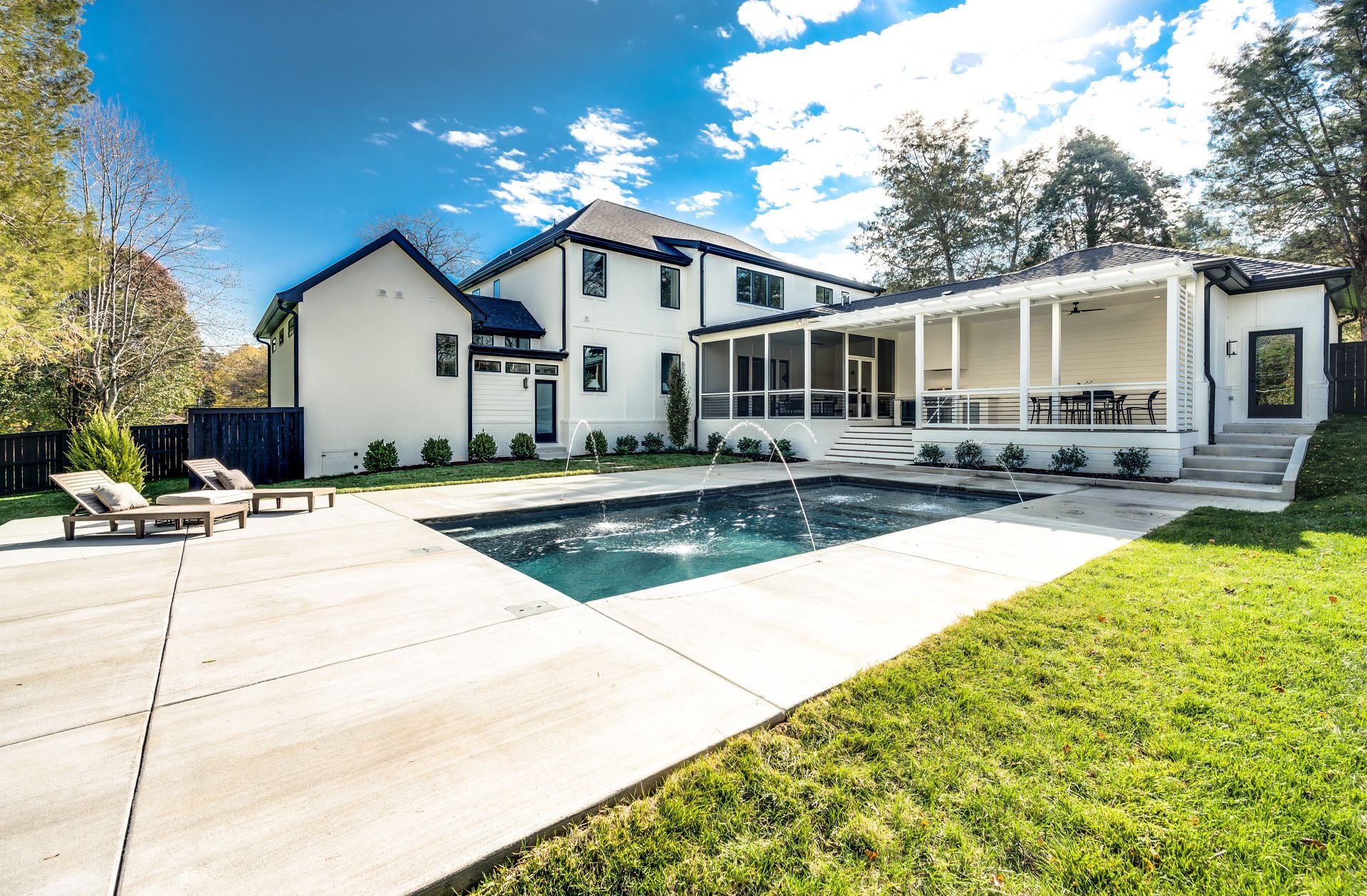 A large white house with a large swimming pool in the backyard