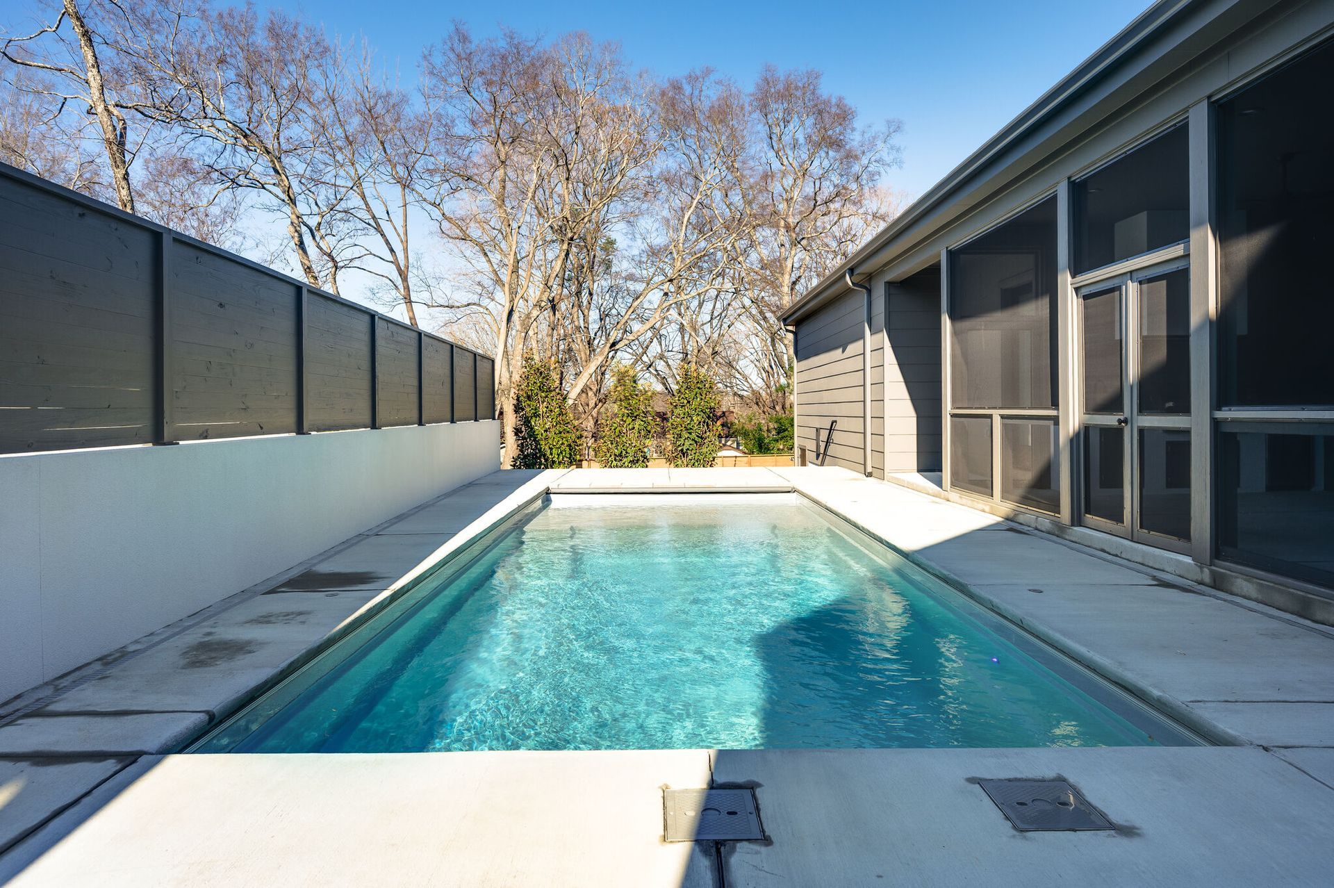 A large swimming pool in the backyard of a house