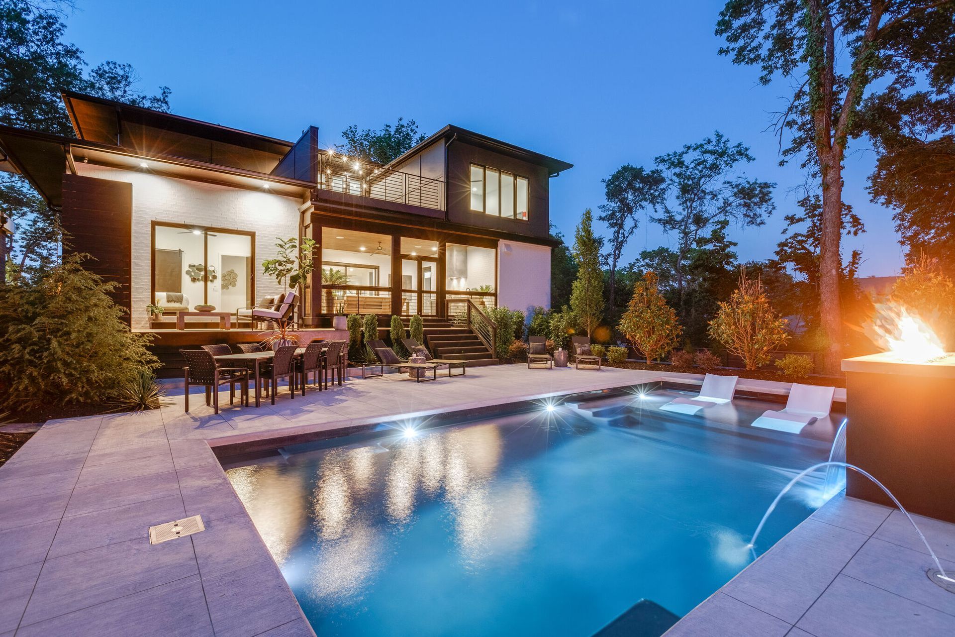 A large house with a swimming pool in front of it.