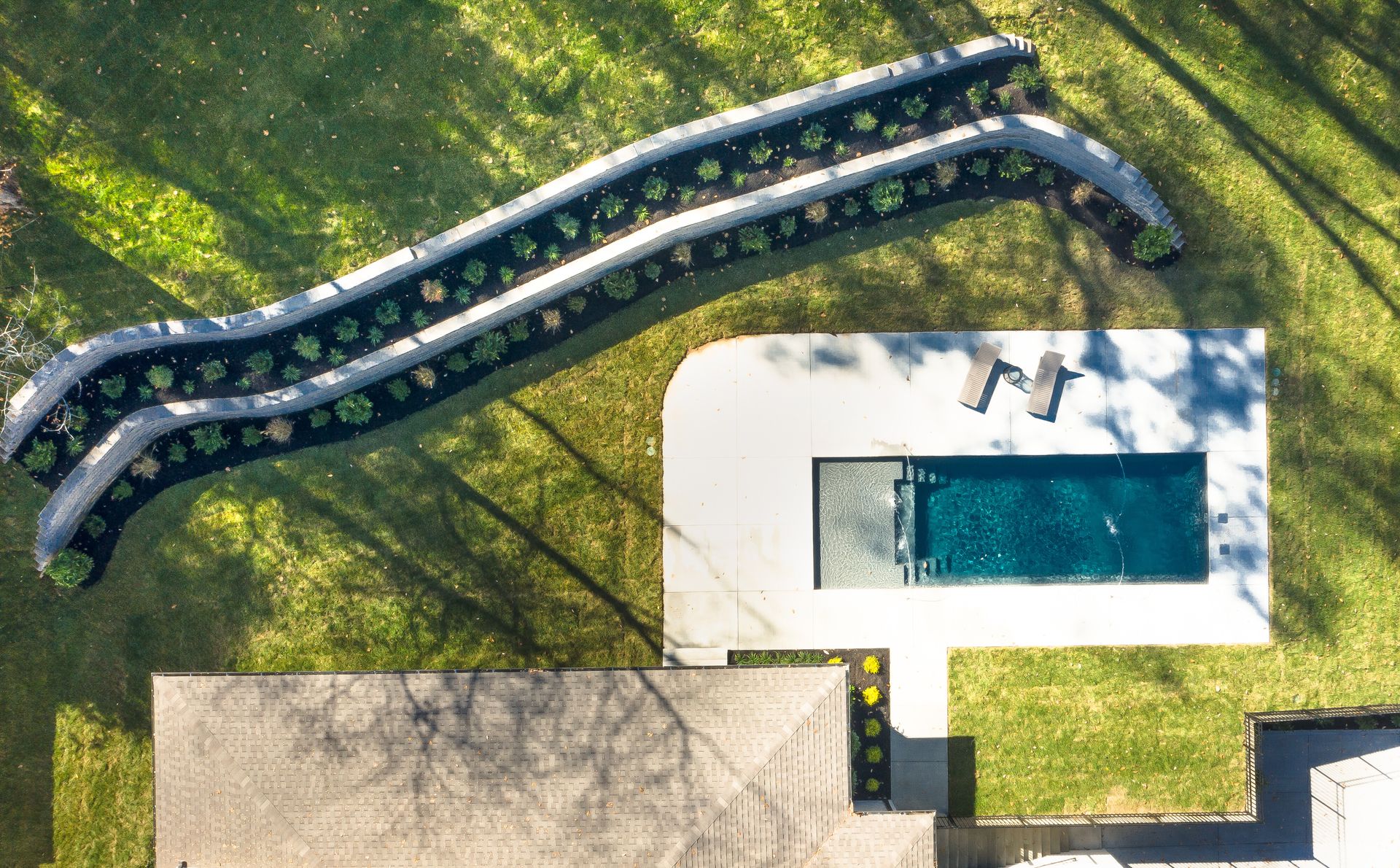 An aerial view of a house with a pool and a slide