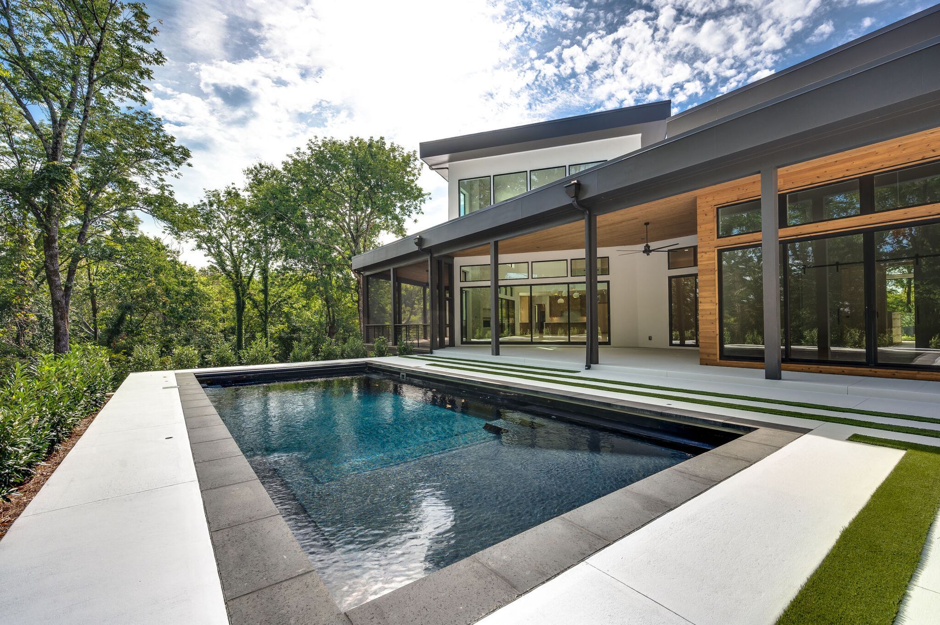 A large house with a large swimming pool in front of it.