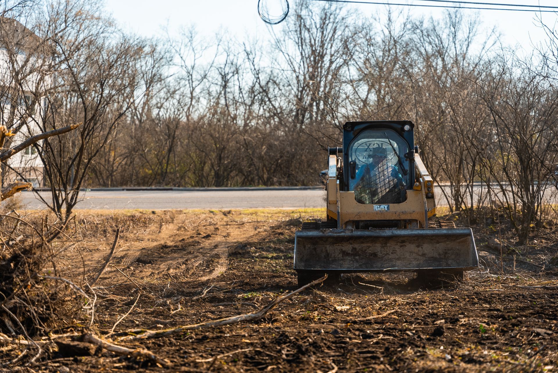 A bulldozer is sitting in the middle of a field.