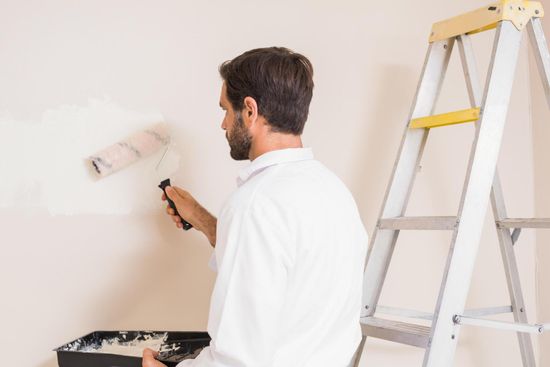 man standing beside the ladder