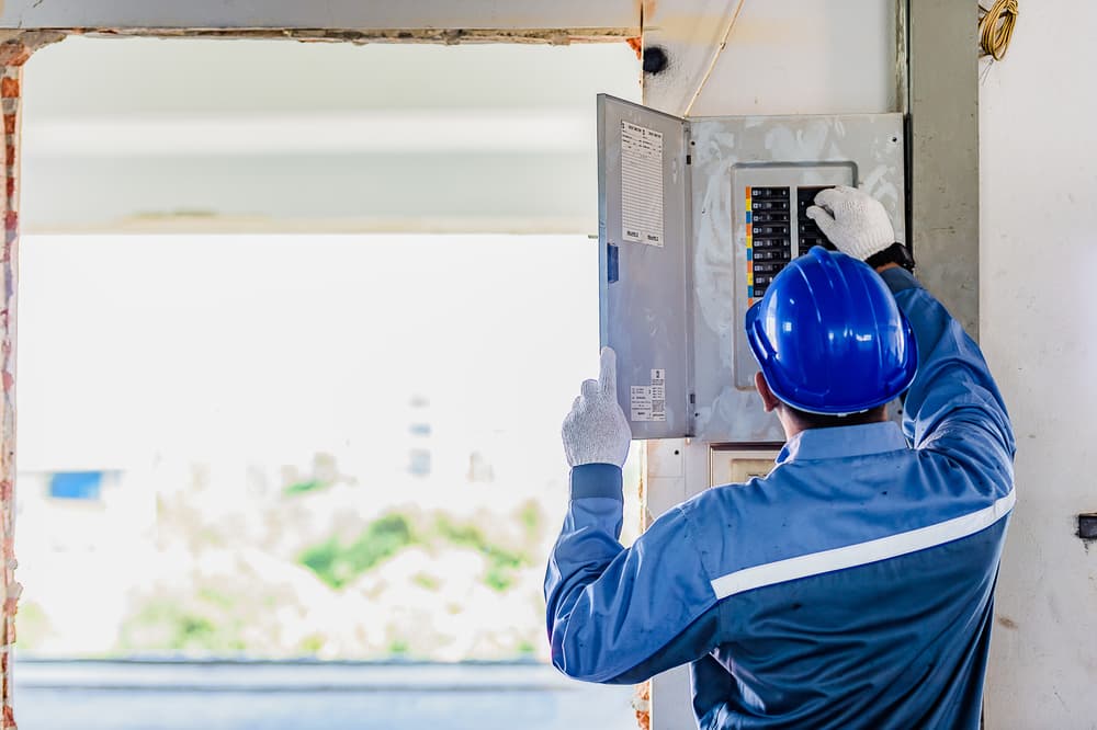 Technician Checks Electric Panel - Mikkelsen Electrical Contractors in Mount Isa, QLD