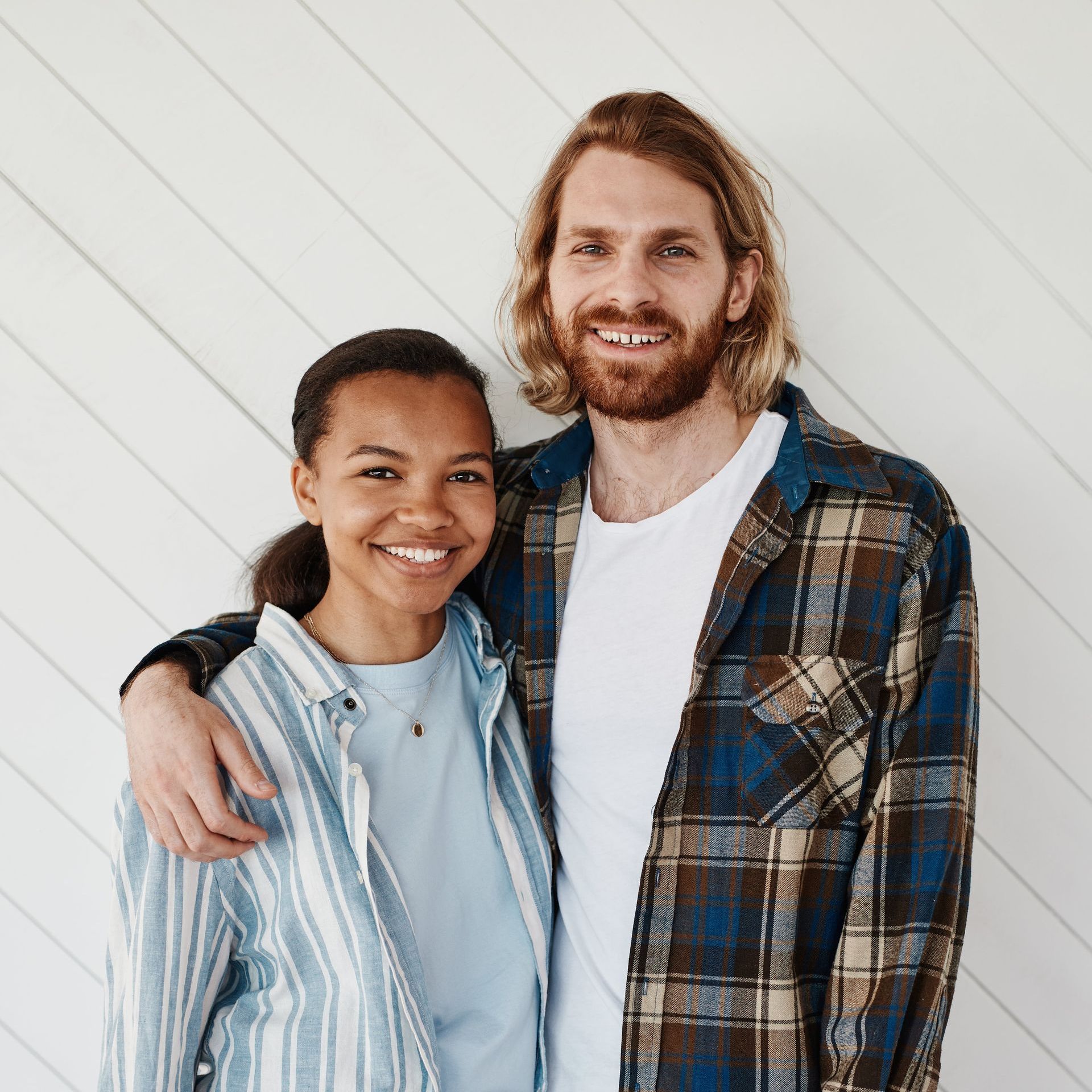 A happy man and a woman are posing for a picture together.