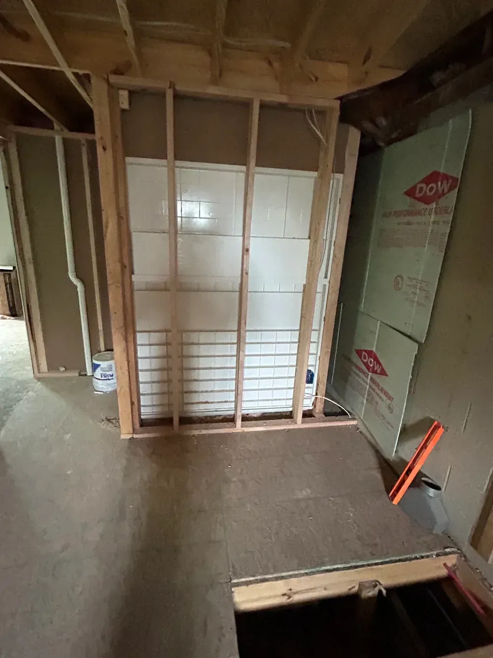 Interior with wooden framing and insulation during renovation.