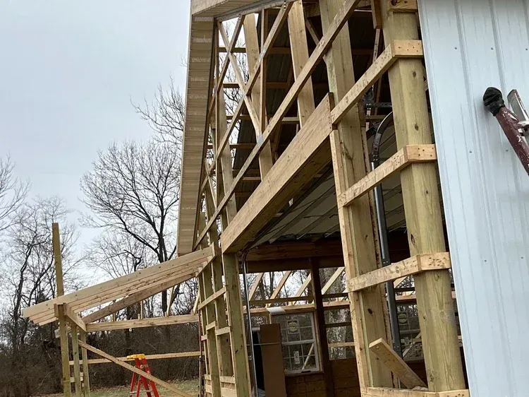 Wooden frame of a building under construction; cloudy day.